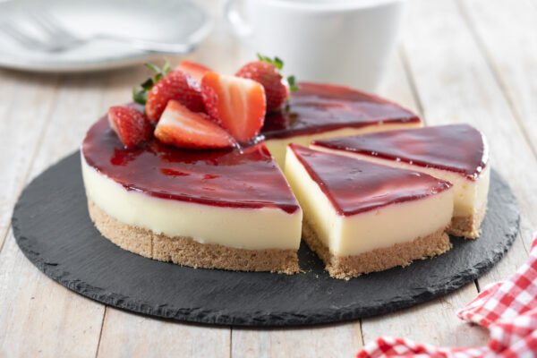 Cheesecake with strawberries on wooden table Cheesecake